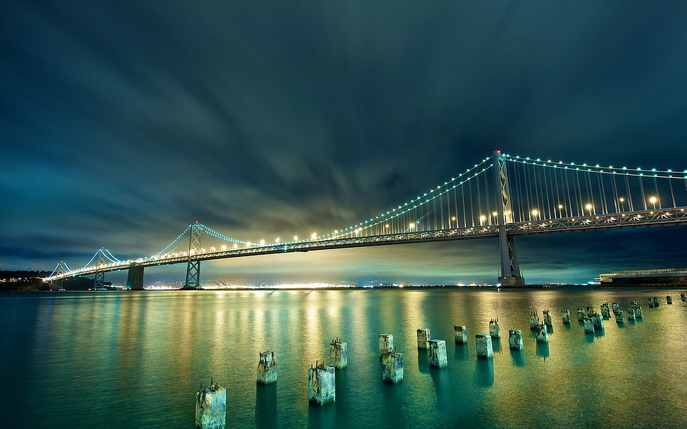 time lapse view of suspension bridge at nighttime HD wallpaper